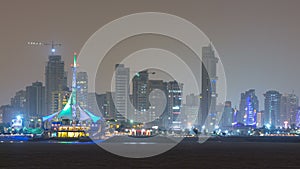 Skyline with Skyscrapers night timelapse in Kuwait City downtown illuminated at dusk. Kuwait City, Middle East