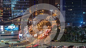 Skyline and traffic on crossroad night timelapse in Kuwait City downtown illuminated at dusk. Kuwait City, Middle East