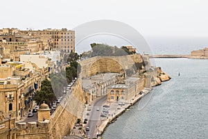 Skyline of Valleta with typical houses and beige limestone walls.