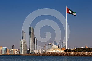 A skyline view of the Abu Dhabi including the UAE National Flag