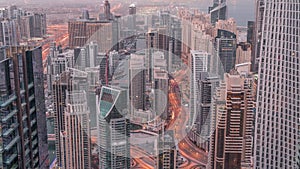 Skyline view of Dubai Marina showing canal surrounded by skyscrapers along shoreline night to day . DUBAI, UAE