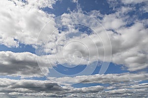 Skyline where fluffy clouds and blue merge, stretching to horizon in intricate patterns