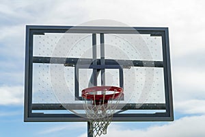 Skylined basketball hoop with clear ventilated backboard and traditional orange rim with white net and black accent