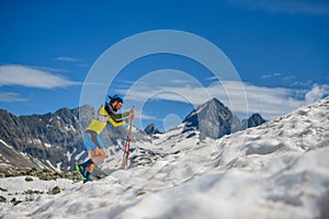 Skyrunning training with sticks on the snow uphill