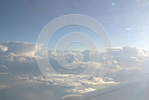 Skyscape - blue sky, white clouds and sun rays; clouds texture