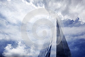 Skyscraper against cloudy sky