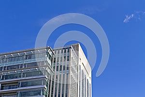 Skyscraper building against blue sky background