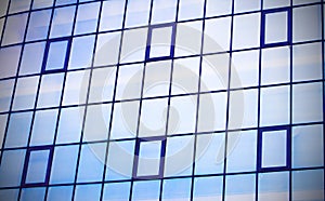 Skyscraper building windows and sky reflection in windows