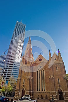 Skyscraper and church in city setting with traffic in Perth