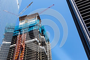 Skyscraper construction with crane on the roof.