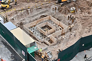 Skyscraper construction site with foundation pit.