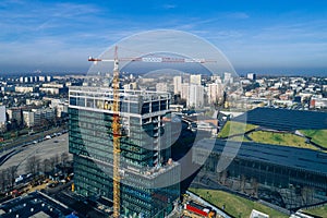 Skyscraper construction with working crane