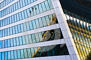 Skyscraper exterior design. Abstract view of window, mirror reflection and detail architecture close-up. Modern office building.