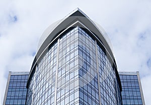 Skyscraper glass facades on a bright sunny day with sunbeams in the blue sky.