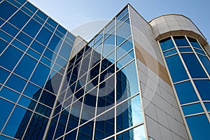 Skyscraper of glass, modern office buildings. High-rise building with reflection window. Facade of business center. Financial down