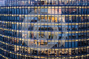 Skyscraper Office windows and office worker by night