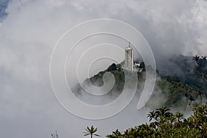 Skyscraper rises above the fog photo