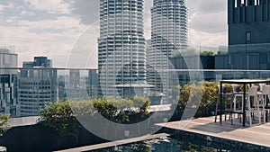 A skyscraper rooftop pool overlooking the city's high-rise buildings