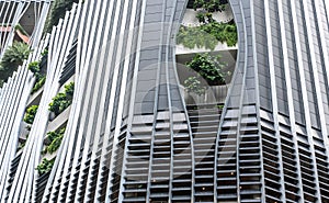 skyscraper in Singapore blends ultramodern design with lush greenery adorning facade, seamless integration of contemporary