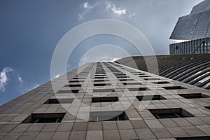 The skyscraper stretches towards the clouds.