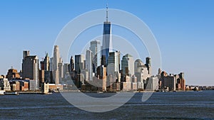 Skyscraper tower buildings in financial business district, cityscape time lapse of boat transportation in New York City, USA