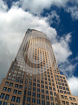 Skyscraper under a cloudy blue sky