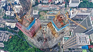 Skyscraper under construction in Jakarta city. Top down cranes on the roof of a skyscraper