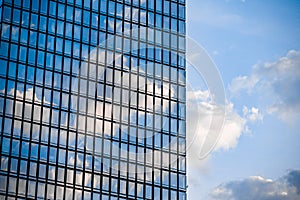 Skyscraper windows close up with blue sky reflection