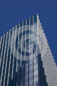 Skyscraper windows reflecting Clouds