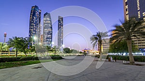 Skyscrapers of Abu Dhabi with Etihad Towers buildings day to night .