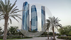 Skyscrapers of Abu Dhabi with Etihad Towers buildings day to night timelapse.