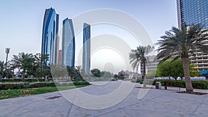 Skyscrapers of Abu Dhabi with Etihad Towers buildings day to night timelapse.