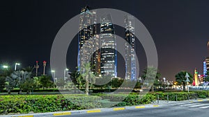 Skyscrapers of Abu Dhabi at night with Etihad Towers buildings .