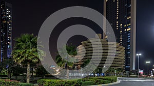 Skyscrapers of Abu Dhabi at night with Etihad Towers buildings .