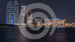 Skyscrapers of Abu Dhabi at night with Etihad Towers buildings timelapse.