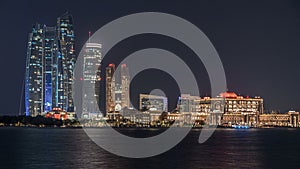 Skyscrapers of Abu Dhabi at night with Etihad Towers buildings timelapse.