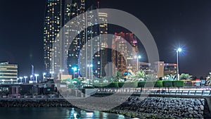 Skyscrapers of Abu Dhabi at night with Etihad Towers buildings timelapse.