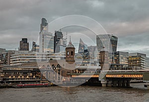 Skyscrapers and The cannon street railway bridge in the business district Looking through Southwark bridge over River thames in