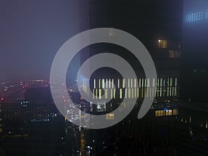 Skyscrapers in the city in the fog at night from a height drone photo