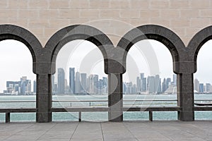 Skyscrapers on the coast, view through arcades