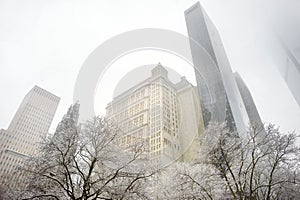 Skyscrapers in the downtown of New York, view from below. Massive snowfall in NYC. Snowy winter weather.