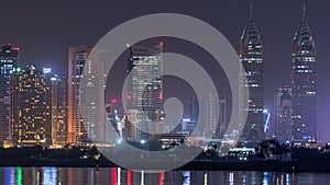 Skyscrapers at the Dubai Internet City illuminated at night timelapse. United Arab Emirates, Middle East