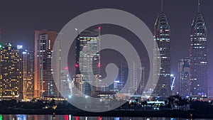 Skyscrapers at the Dubai Internet City illuminated at night timelapse. United Arab Emirates, Middle East