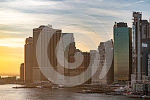 Skyscrapers in lower Manhattan overlooking the East River during a winter sunset, New York