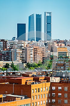 Skyscrapers of Madrid's financial district emerge among the buildings of the city, Spain. photo