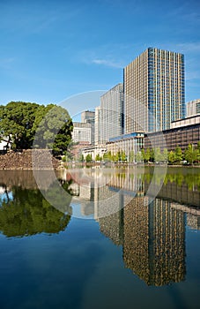 Skyscrapers of Marunouchi district reflecting in the water of Edo castle outer moat. Tokyo. Japan