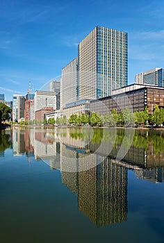 Skyscrapers of Marunouchi district reflecting in the water of Edo castle outer moat. Tokyo. Japan