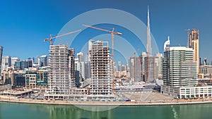 Skyscrapers near canal in Dubai with blue sky aerial timelapse