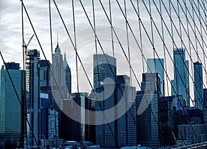 skyscrapers of New York. view through the grille of the Brooklyn Bridge