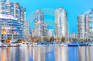 Skyscrapers reflection along False Creek riverside in Vancouver BC at blue hour